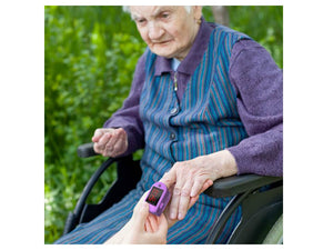 Senior Citizen Using the Zacurate 500DL-M Pro Series Fingertip Pulse Oximeter Purple