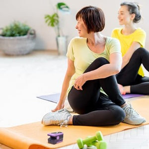  Ladies in yoga class with the Zacurate 500C Pulse Oximeter on the yoga mat 